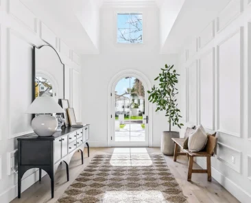Close-up of the Arcadia home’s front entry with arched door, luxury trim details, and craftsmanship by Phoenix General Contractors.