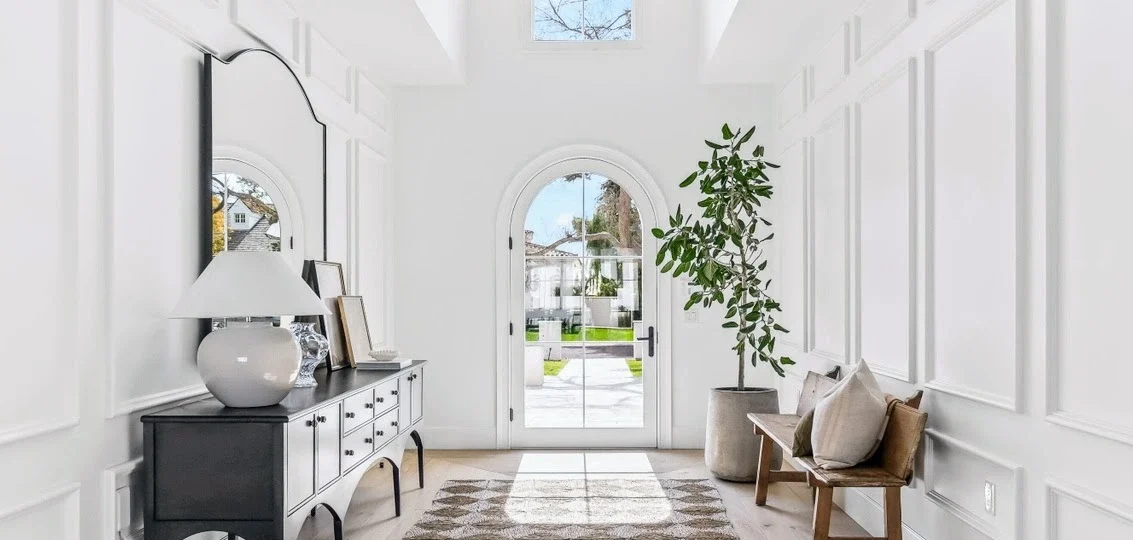 Close-up of the Arcadia home’s front entry with arched door, luxury trim details, and craftsmanship by Phoenix General Contractors.