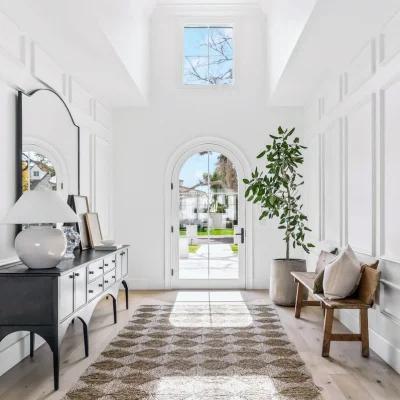 Close-up of the Arcadia home’s front entry with arched door, luxury trim details, and craftsmanship by Phoenix General Contractors.