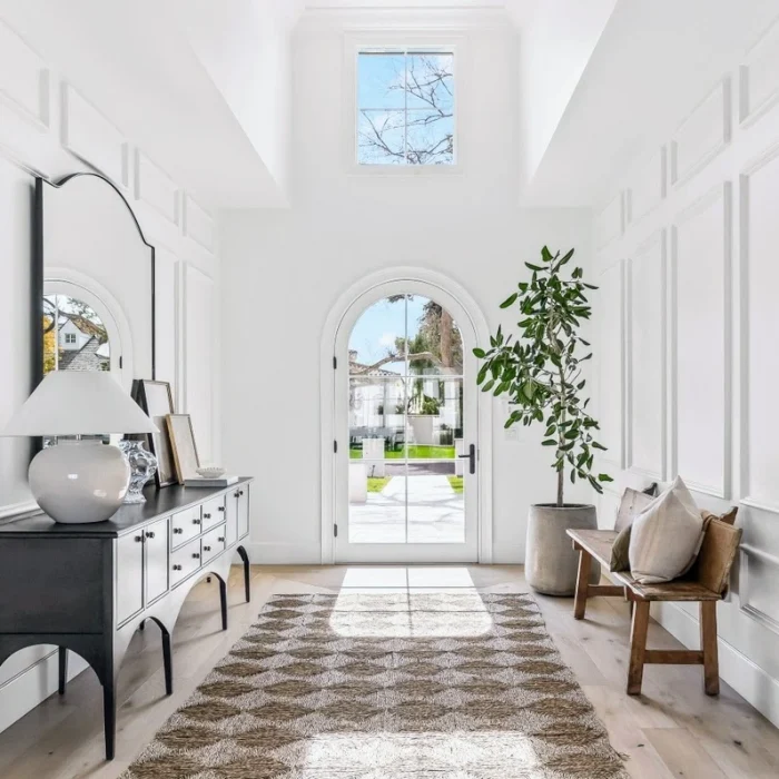 Close-up of the Arcadia home’s front entry with arched door, luxury trim details, and craftsmanship by Phoenix General Contractors.