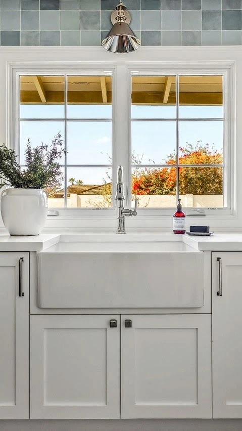 Arcadia laundry room with a farmhouse sink and a scenic view of Camelback Mountain by Phoenix General Contractors.