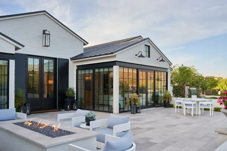 Front of custom home by Phoenix Home Builder McIntyre Development with 180-degree office windows, steel I-beams, and standing seam metal roof.
