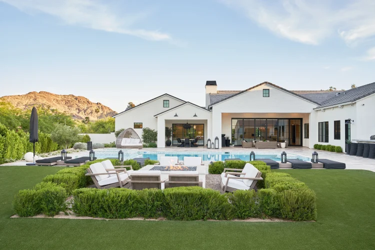 Rear view of custom home and landscaped yard by Phoenix Home Builder McIntyre Development, with Mummy Mountain in the background.